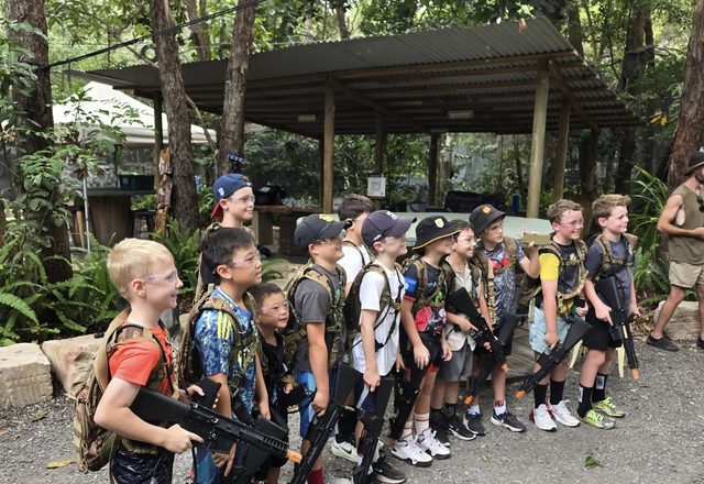 A birthday group lined up in camo gear