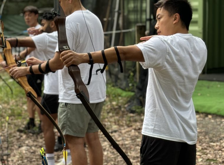 An archer at full draw on the line
