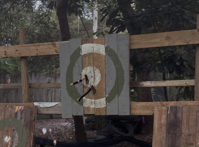Axes stuck in the timber scoring targets on the outdoor lanes