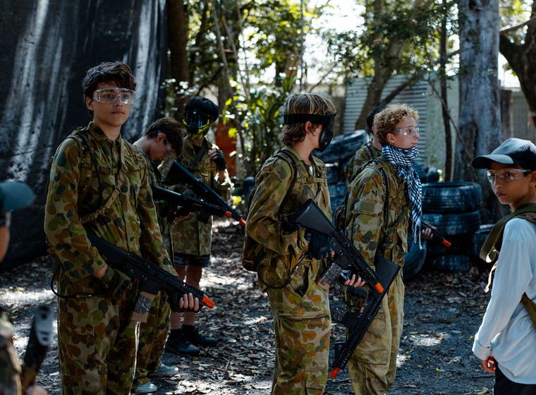 An adult group in camo between rounds