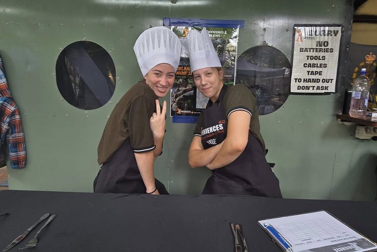 Two judges in chef hats at a corporate cook-off