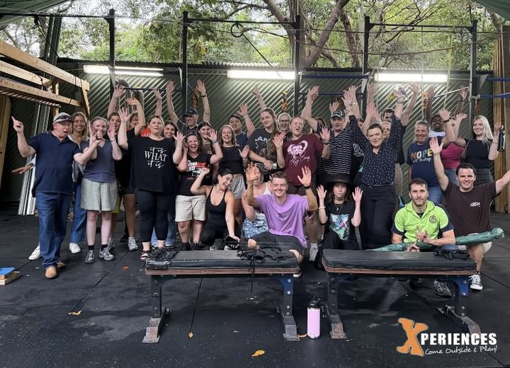 A big group celebrating in the Base Gym at XperiencesHQ, Twin Waters