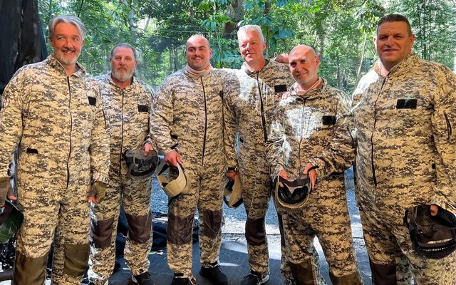 A paintball group in full camo after a game
