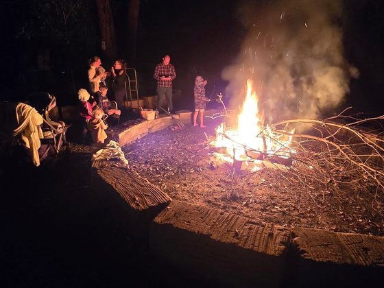 A fire pit burning at an evening event
